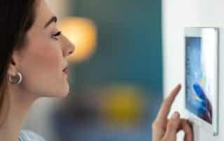 home automation Vero Beach Florida woman using control panel